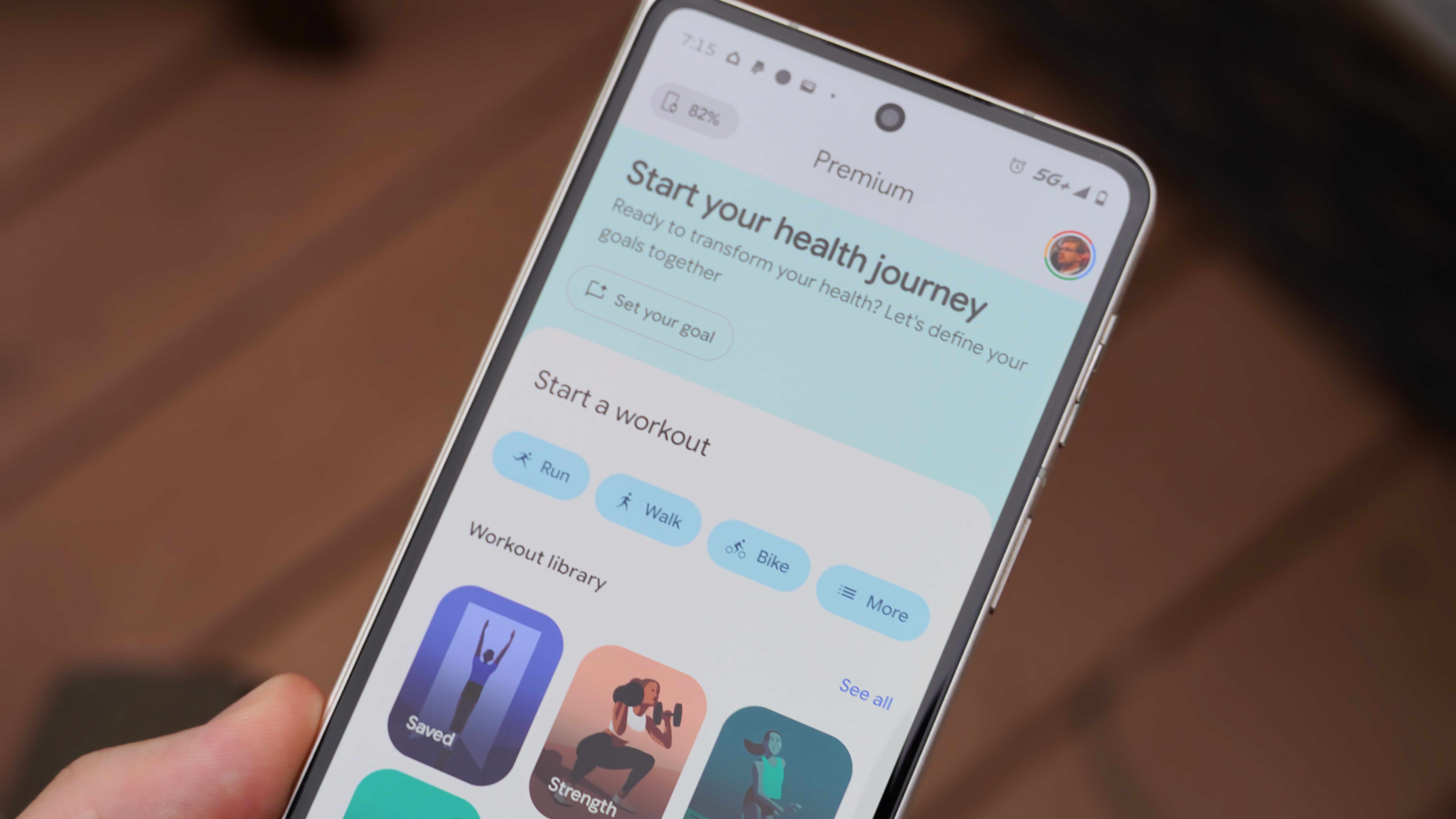 The Fitbit Air in a Lavender band and the Google Health app settings.