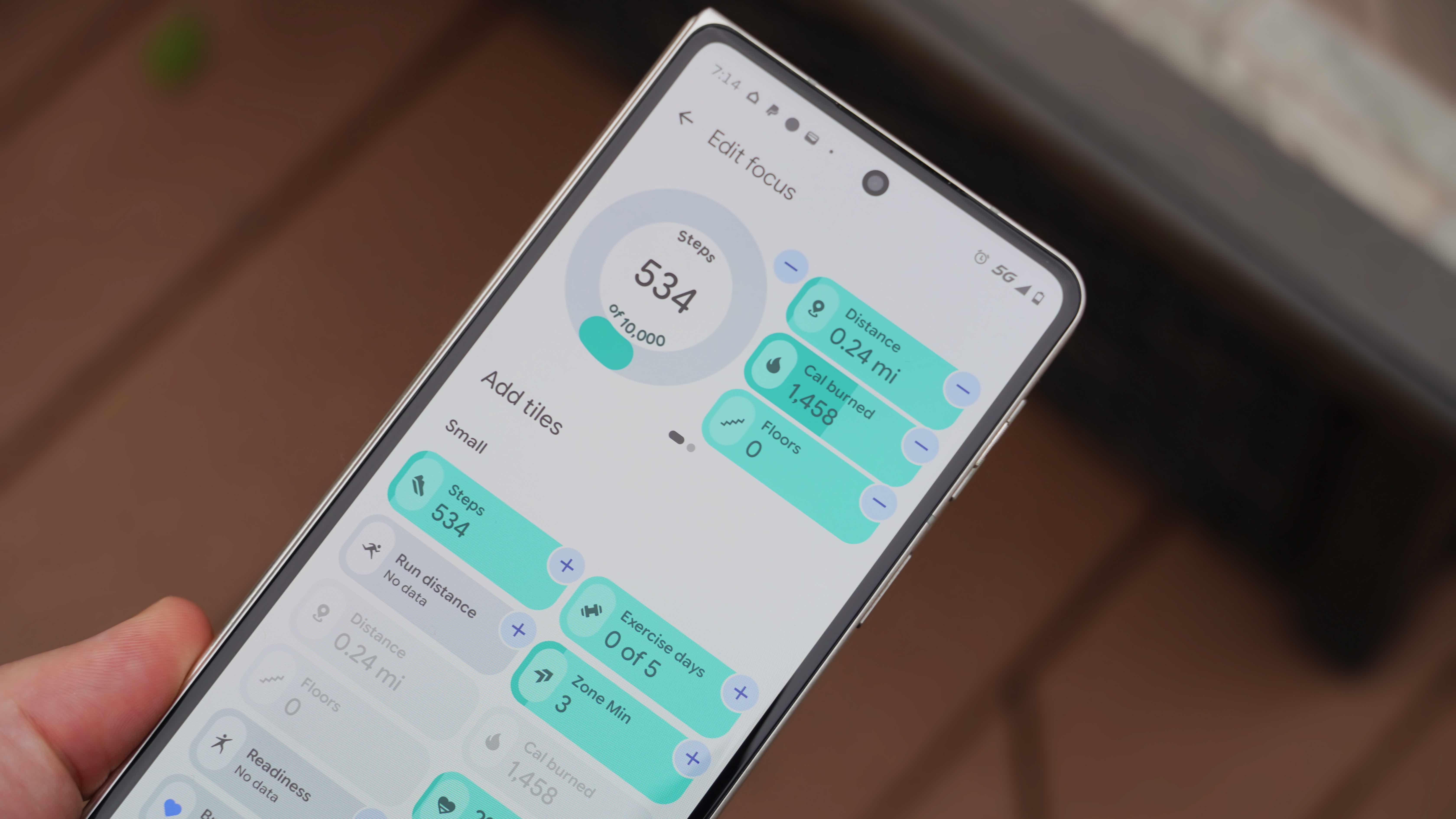 The Fitbit Air in a Lavender band and the Google Health app settings.